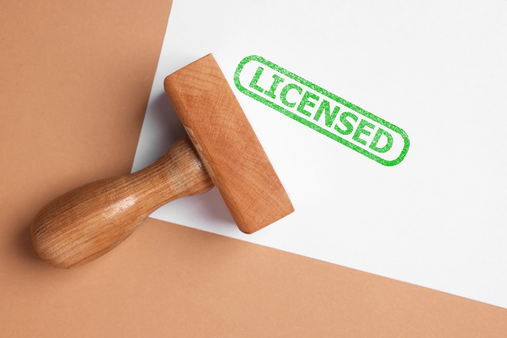 Sheet,Of,Paper,With,Word,Licensed,And,Stamp,On,Beige